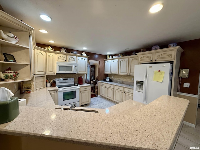 106 Jeremy Dr, Carterville, IL 62918 - kitchen featuring decorative backsplash, a sink, a peninsula, white appliances, and light tile patterned flooring