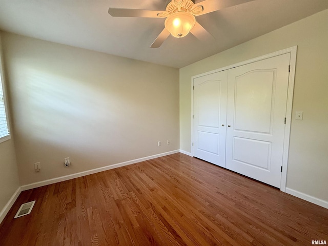106 Jeremy Dr, Carterville, IL 62918 - unfurnished bedroom with baseboards, a closet, wood finished floors, and visible vents