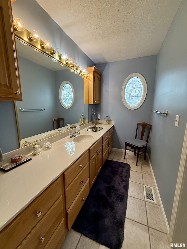 106 Jeremy Dr, Carterville, IL 62918 - bathroom featuring visible vents, tile patterned flooring, vanity, baseboards, and a textured ceiling