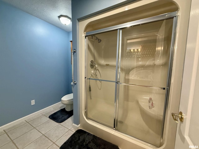 106 Jeremy Dr, Carterville, IL 62918 - full bathroom with toilet, tile patterned floors, a shower stall, and baseboards
