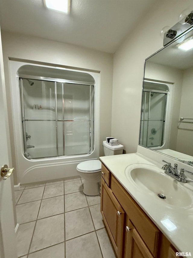 106 Jeremy Dr, Carterville, IL 62918 - full bath featuring shower / bath combination with glass door, toilet, tile patterned flooring, and vanity