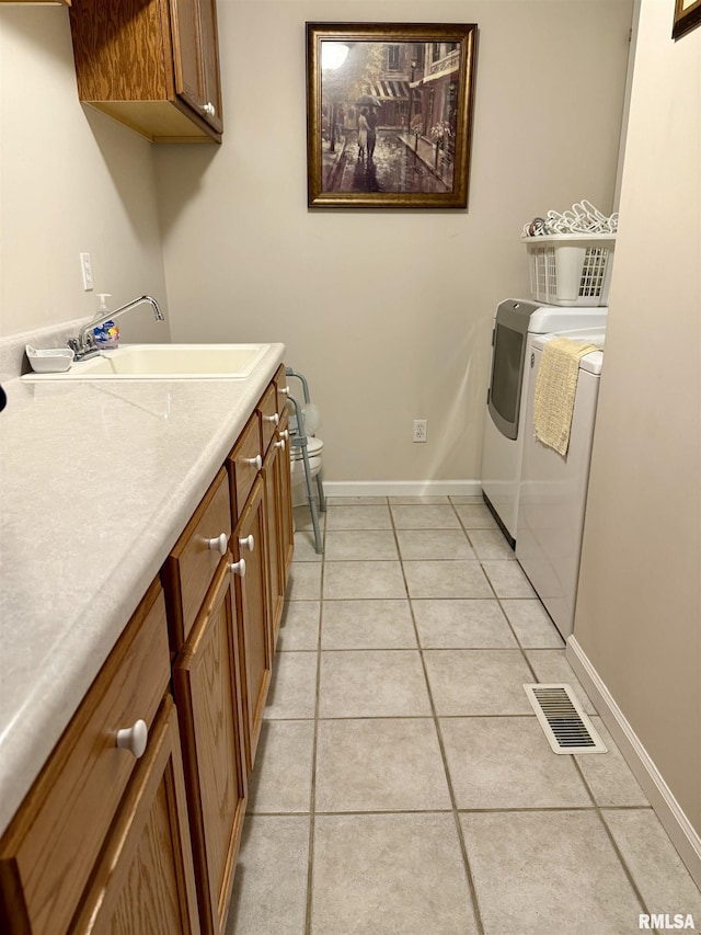 106 Jeremy Dr, Carterville, IL 62918 - laundry area with cabinet space, light tile patterned floors, visible vents, and washer and clothes dryer