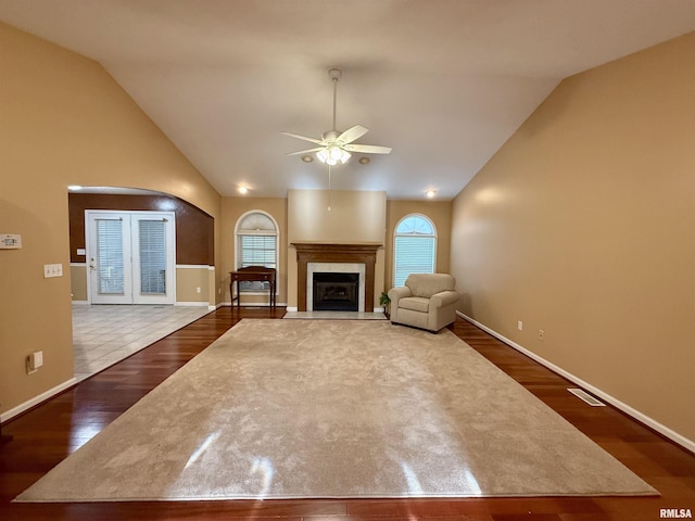 106 Jeremy Dr, Carterville, IL 62918 - unfurnished living room featuring ceiling fan, arched walkways, dark wood finished floors, baseboards, and lofted ceiling