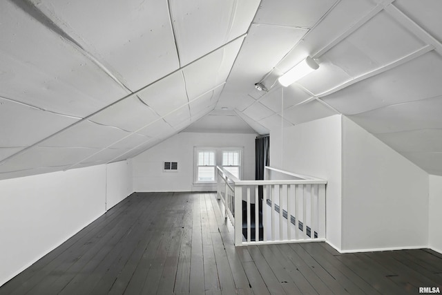 bonus room with visible vents, wood-type flooring, and vaulted ceiling