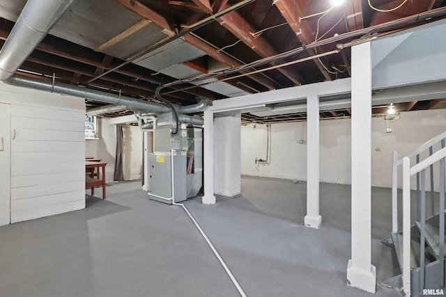 below grade area with heating unit and stairs