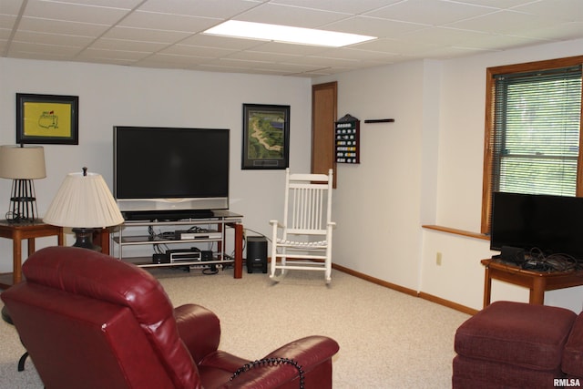 carpeted living room featuring baseboards