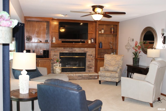 living area featuring a ceiling fan, light carpet, and a fireplace