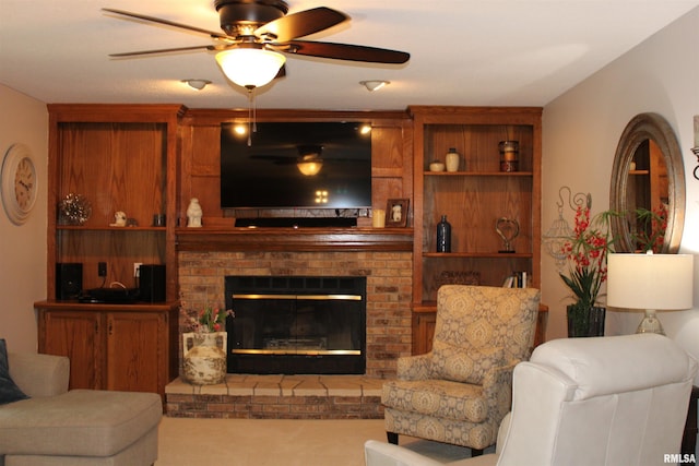 living area with a ceiling fan, carpet flooring, and a brick fireplace