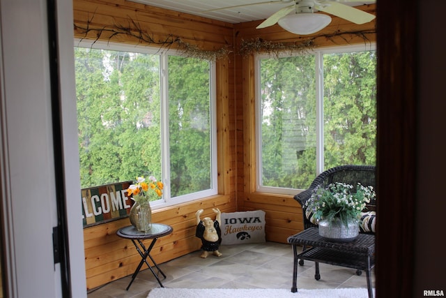 sunroom / solarium featuring wooden walls