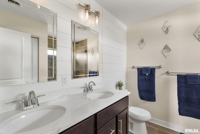 1824 S 5th St, Eldridge, IA 52748 - full bathroom featuring double vanity, toilet, visible vents, and a sink