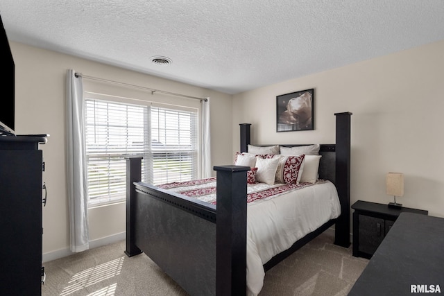 1824 S 5th St, Eldridge, IA 52748 - bedroom featuring light colored carpet, a textured ceiling, baseboards, and visible vents