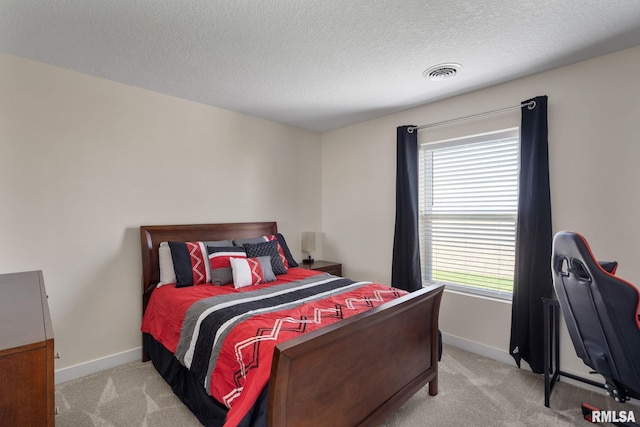 1824 S 5th St, Eldridge, IA 52748 - bedroom with visible vents, a textured ceiling, baseboards, and light carpet