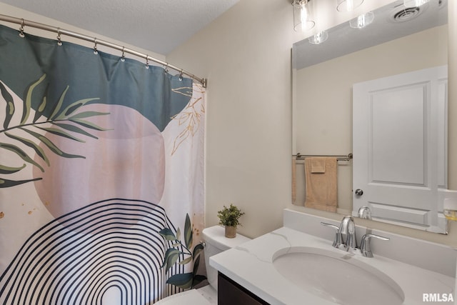1824 S 5th St, Eldridge, IA 52748 - bathroom with vanity, toilet, and a textured ceiling