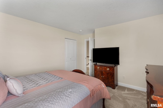 1824 S 5th St, Eldridge, IA 52748 - bedroom featuring baseboards, a closet, and light colored carpet