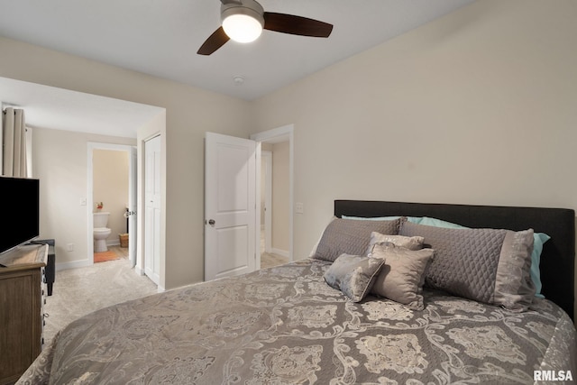 1824 S 5th St, Eldridge, IA 52748 - carpeted bedroom featuring connected bathroom, baseboards, and ceiling fan