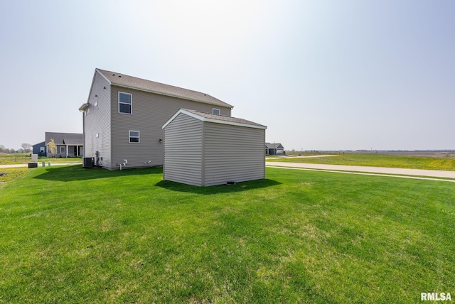 1824 S 5th St, Eldridge, IA 52748 - view of side of property featuring an outdoor structure, a lawn, central air condition unit, and a storage shed