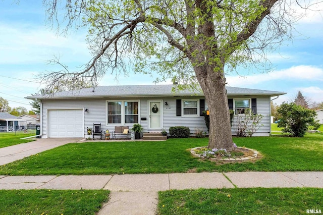 ranch-style house featuring entry steps, an attached garage, driveway, and a front yard