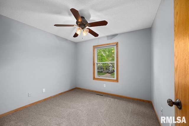 unfurnished room featuring carpet floors, baseboards, a ceiling fan, and a textured ceiling