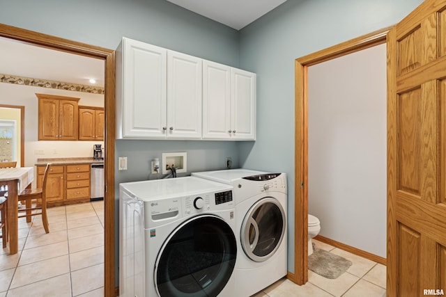 laundry area featuring light tile patterned floors and washing machine and clothes dryer