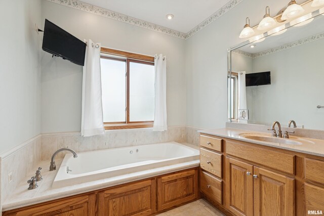 bathroom featuring tile patterned floors, a bath, and vanity