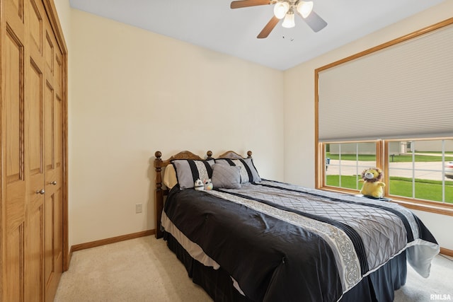 bedroom with baseboards, light colored carpet, and ceiling fan