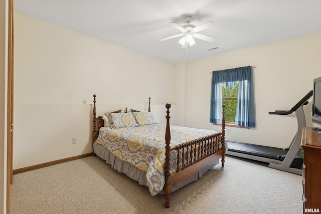 bedroom with a ceiling fan, visible vents, baseboard heating, baseboards, and light carpet
