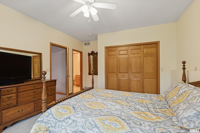 bedroom with a ceiling fan, visible vents, light carpet, and a closet