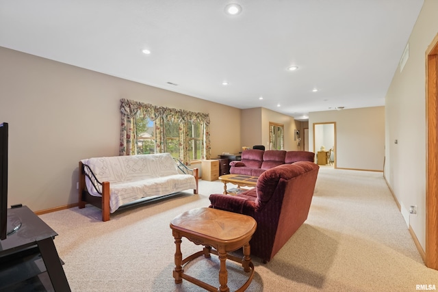 living area with baseboards, light carpet, and recessed lighting