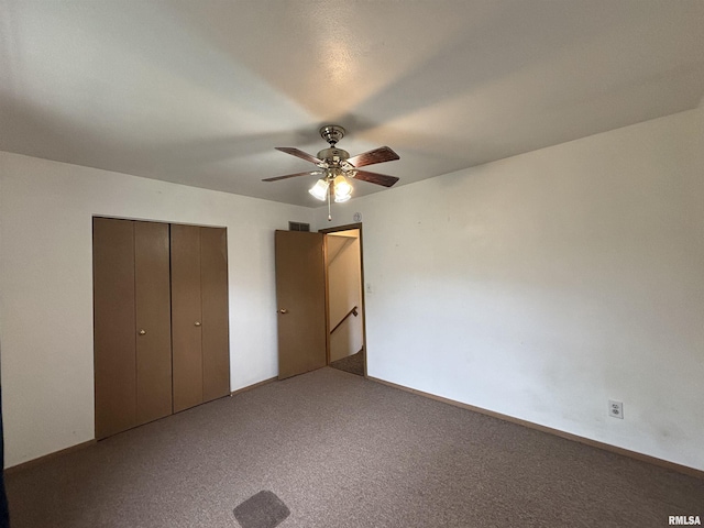 unfurnished bedroom featuring ceiling fan, visible vents, carpet, and a closet