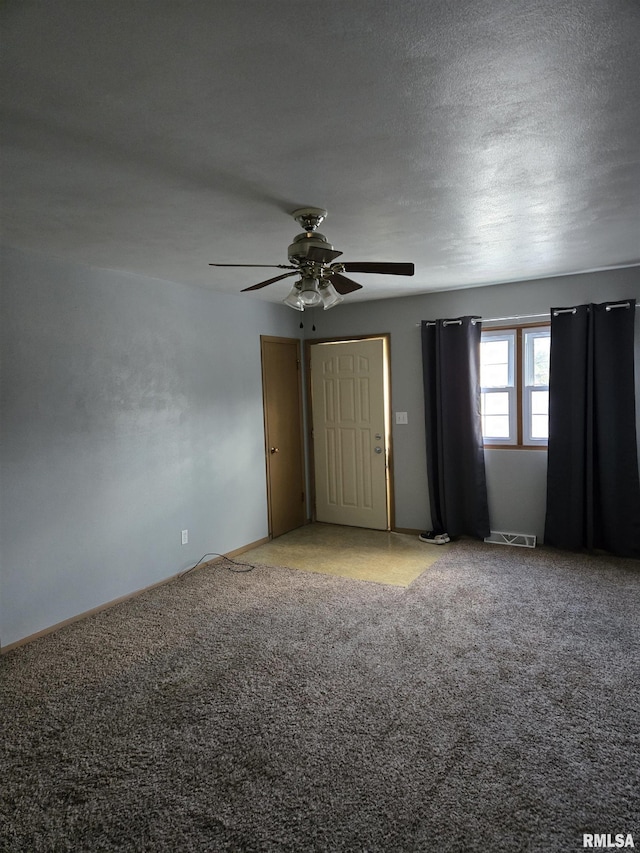 unfurnished bedroom with carpet floors, baseboards, a ceiling fan, and visible vents