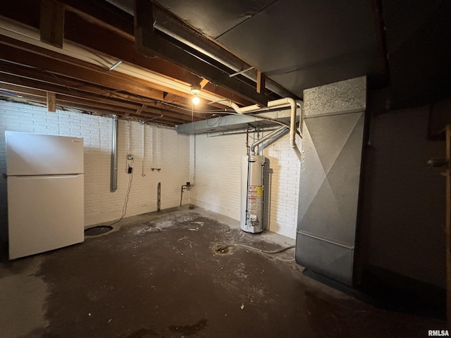 unfinished basement with freestanding refrigerator and water heater