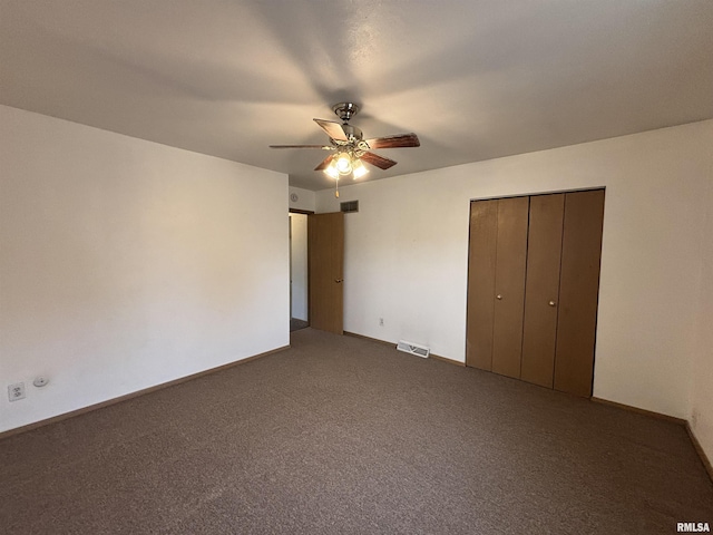 unfurnished bedroom featuring visible vents, carpet, baseboards, and a closet
