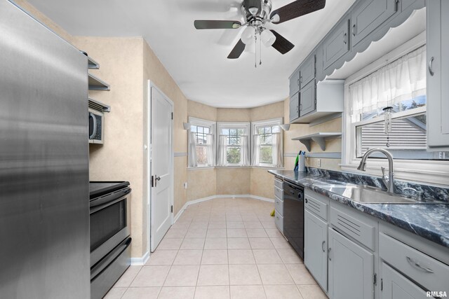 kitchen featuring open shelves, a sink, ceiling fan, and stainless steel appliances
