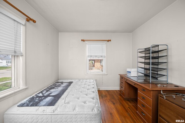 bedroom with baseboards and dark wood finished floors