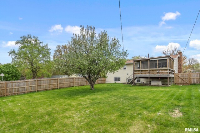 view of yard with a fenced backyard, stairs, and a sunroom