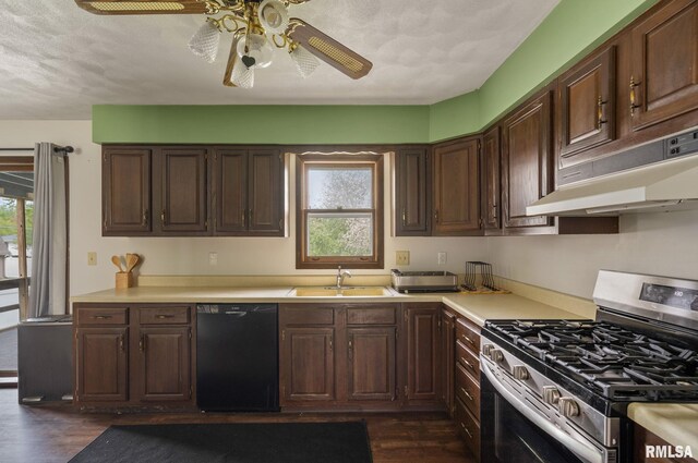 kitchen with dark wood-style flooring, stainless steel gas stove, under cabinet range hood, a sink, and dishwasher