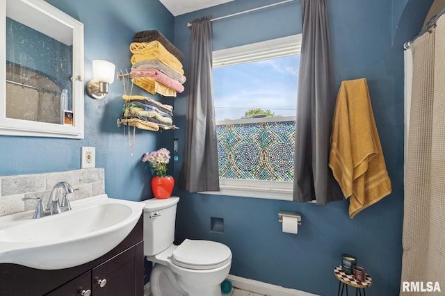 full bathroom with toilet and vanity