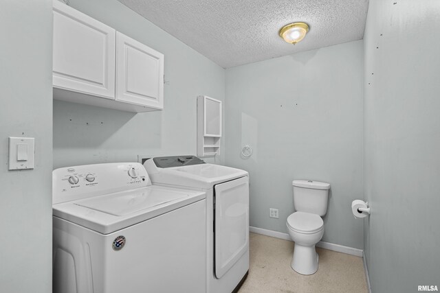laundry room with separate washer and dryer, laundry area, a textured ceiling, and baseboards