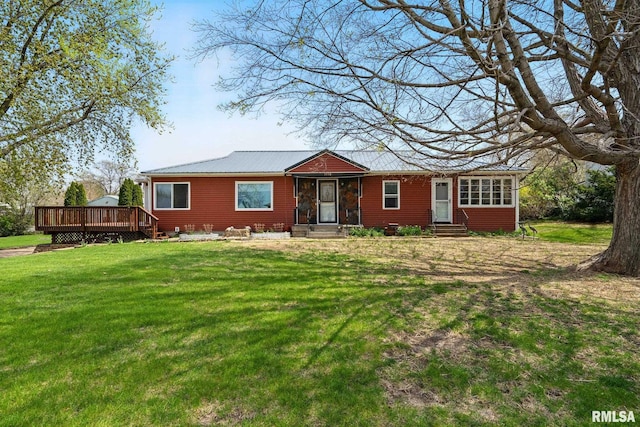 exterior space with a deck, a front yard, and entry steps
