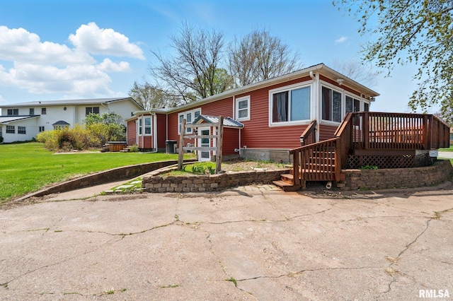 view of front facade with a front lawn, central AC, and a deck