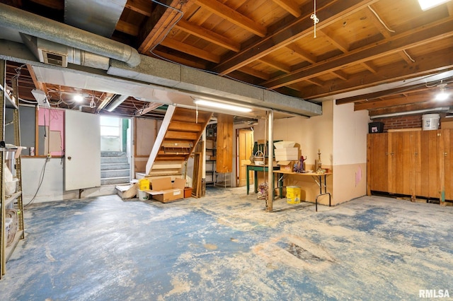 basement with visible vents and stairs