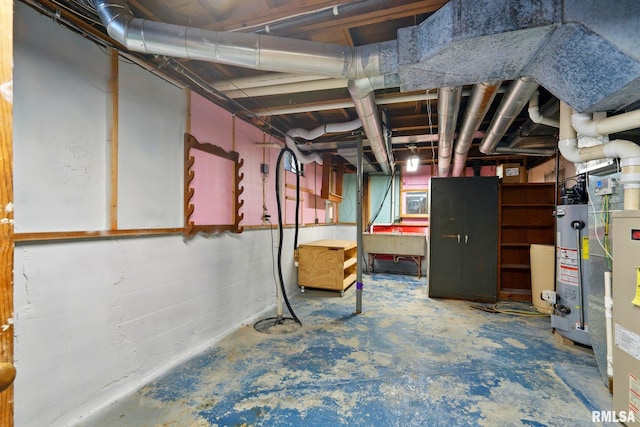 unfinished basement featuring a sink and water heater