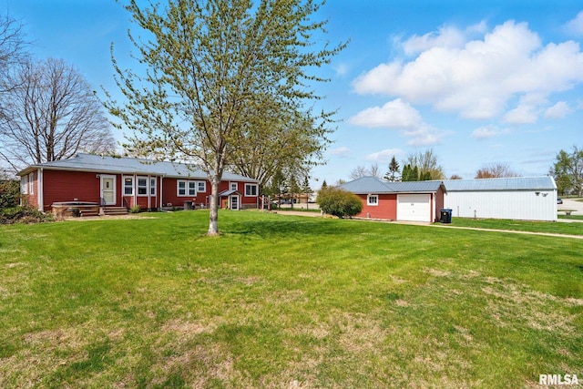 1118 Cedar St, Tipton, IA 52772 - view of green lawn featuring an outdoor structure and entry steps