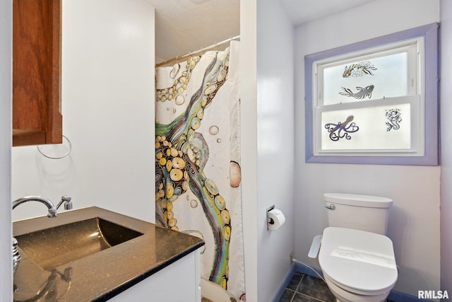bathroom featuring toilet, tile patterned floors, a shower with curtain, and vanity