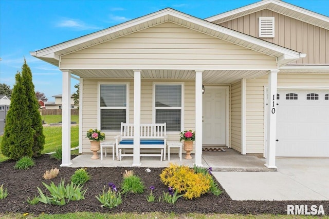 view of front of house featuring an attached garage and a porch
