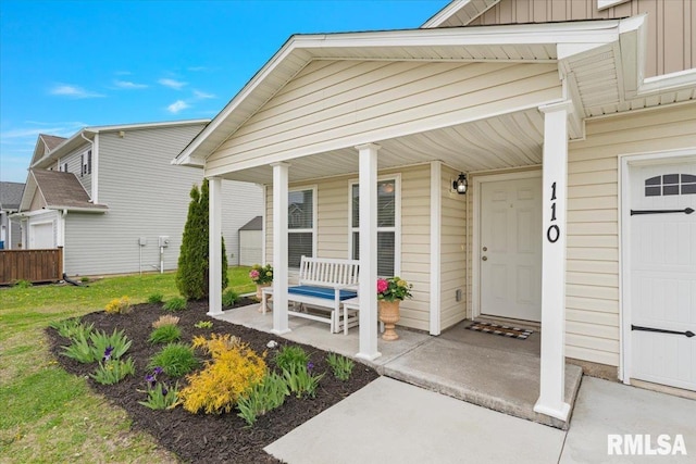 property entrance with covered porch and board and batten siding