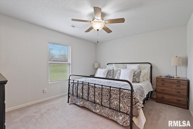 bedroom featuring carpet floors, ceiling fan, visible vents, and baseboards