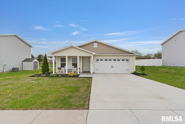 ranch-style home featuring a front lawn, a garage, a porch, a shed, and concrete driveway