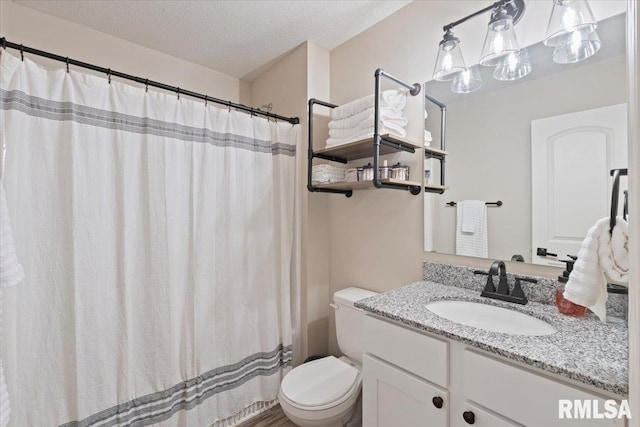 bathroom featuring vanity, a textured ceiling, curtained shower, and toilet