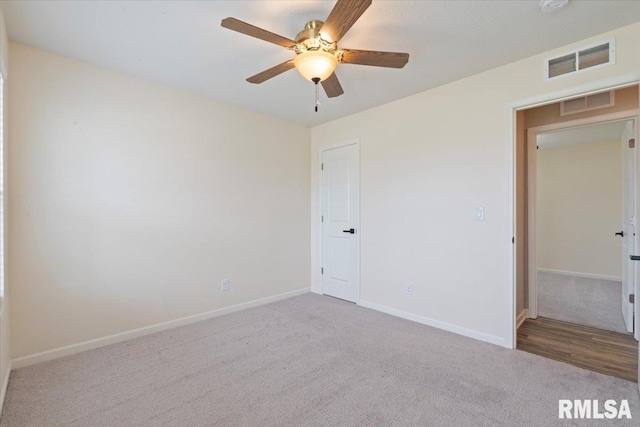 unfurnished bedroom featuring baseboards, visible vents, and carpet